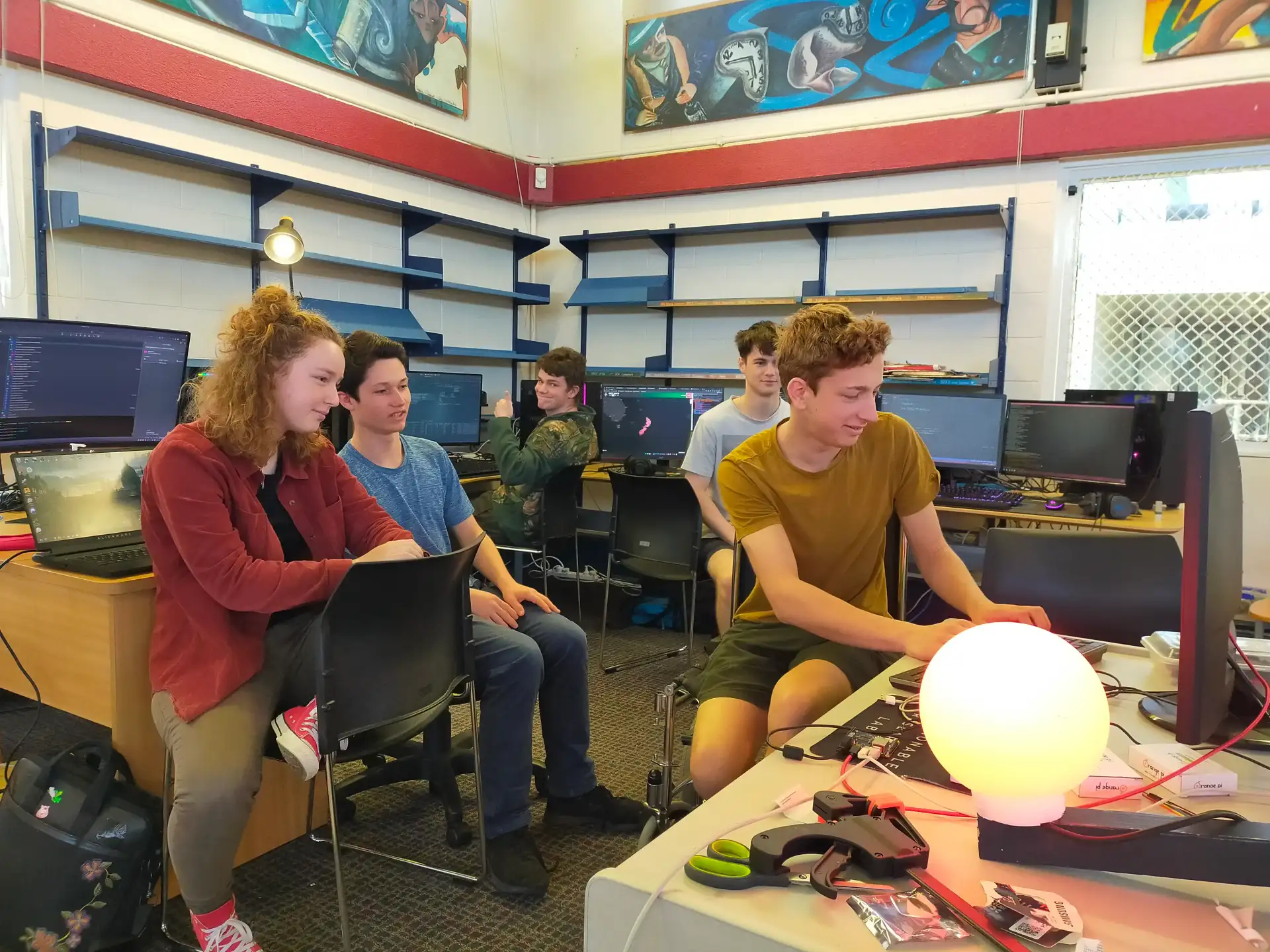 Team sitting around the first prototype globe